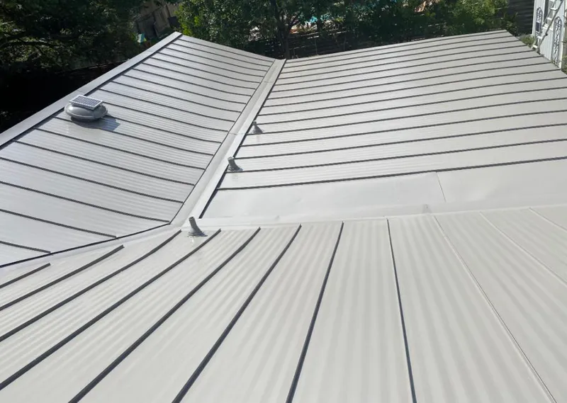 Solar attic fan installed on a metal roof for Roof Ventilation in Breitung